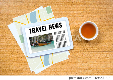 travel news, concept with digital tablet over paper city map travel news, concept with digital tablet over paper city map 69351928