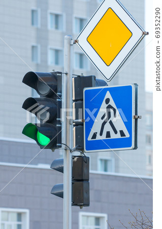 green traffic light, pedestrian crosswalk and main road traffic signs 69352290