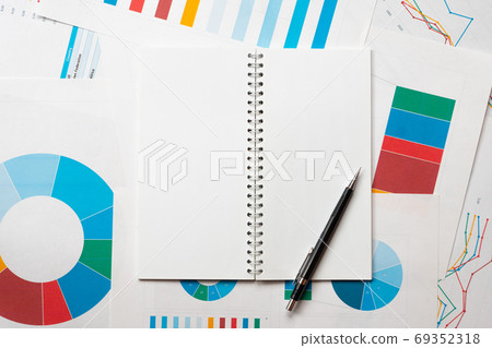 empty notepad with pencil over business charts, research or analysis template with copy space 69352318