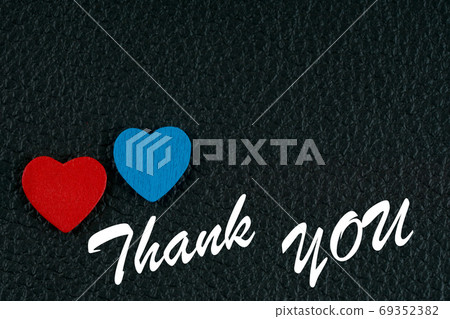 red and blue wooden hearts with thank you phrase on black leather red and blue wooden hearts with thank you phrase on black leather 69352382