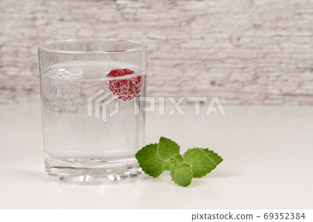 refreshment or detox water with mint and raspberry in high glass 69352384