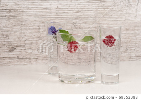refreshment or detox water with mint and raspberry in high glass refreshment or detox water with mint and raspberry in high glass 69352388