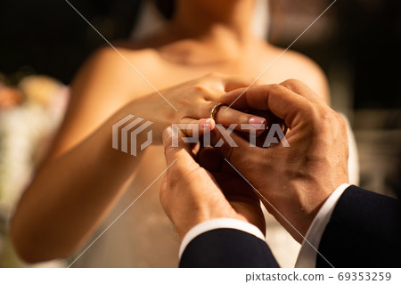 groom and bride put on each other rings. wedding. 69353259