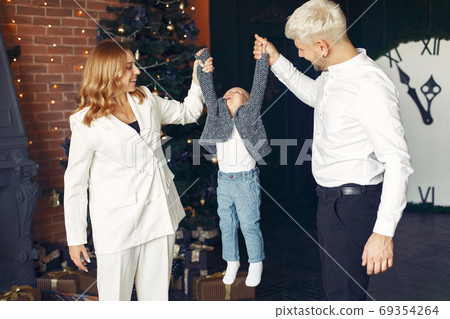 Family with little son at home near christmas tree 69354264