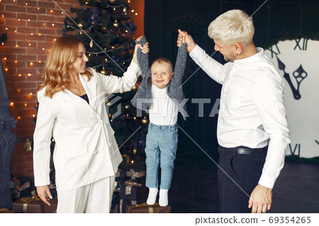 Family with little son at home near christmas tree 69354265