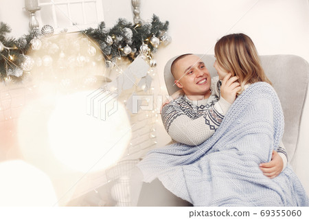 Couple spend time at home with christmas decorations 69355060