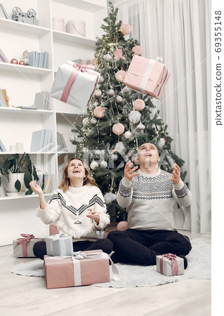 Couple spend time at home with christmas decorations 69355148