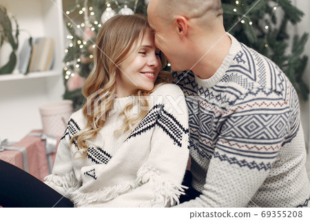 Couple spend time at home with christmas decorations 69355208