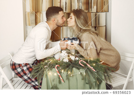 Couple spend time at home with christmas decorations 69356023