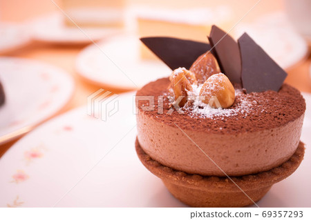 Chocolate mousse tart cake topped with nuts 69357293