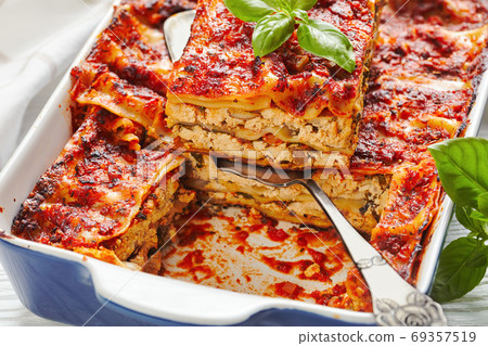 Vegan low-fat tofu lasagna on a white wooden table 69357519