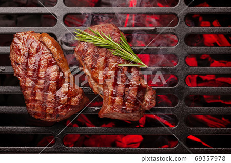 Beef steaks cooking on grill Beef steaks cooking on grill 69357978