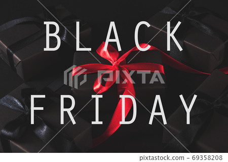 gift box wrapped black paper and black bow ribbon present around gift box wrapped black paper and black bow ribbon present around 69358208