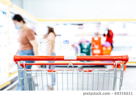 Shopping cart in supermarket, Abstract blurred photo in shopping malls, Cart in the market concept. Shopping cart in supermarket, Abstract blurred photo in shopping malls, Cart in the market concept. 69358831