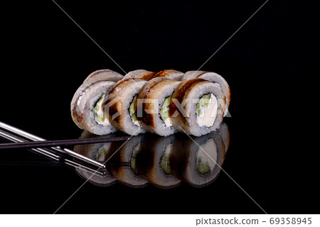 Fresh delicious beautiful sushi rolls on a dark background Fresh delicious beautiful sushi rolls on a dark background 69358945