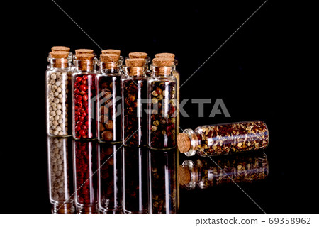 Small glass jars with corks with various spices inside Small glass jars with corks with various spices inside 69358962