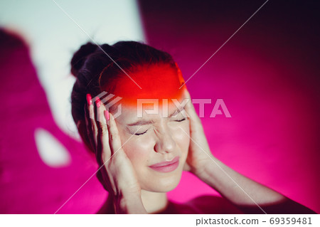 Young woman with headache and red color forehead Young woman with headache and red color forehead 69359481