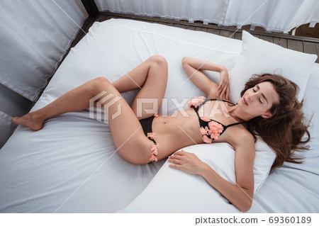 Young Woman wearing bikini enjoying her summer 69360189