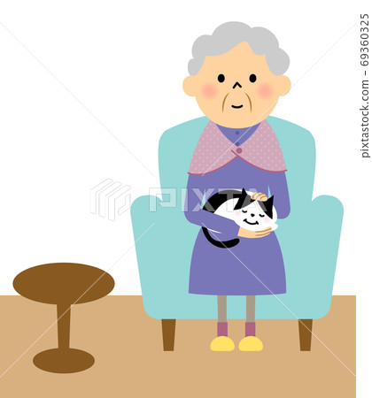 Grandma sitting on the sofa holding a cat 69360325