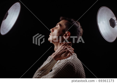 Dark portrait of a man looking up Dark portrait of a man looking up 69361173