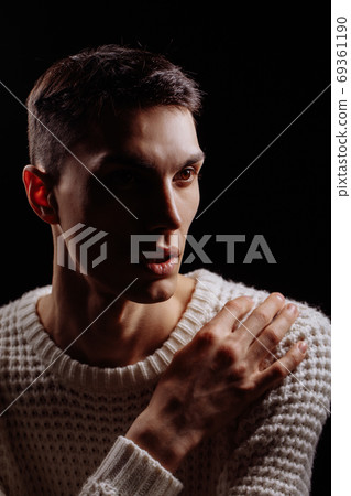 Studio shot of a handsome young male model wearing white T-shirt and sunglasses 69361190