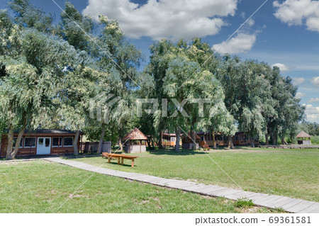 Modern wooden recreational houses on the riverbank. 69361581
