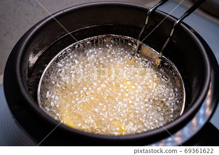 French fries. oil boiling in a deep fryer at home. French fries. oil boiling in a deep fryer at home. 69361622
