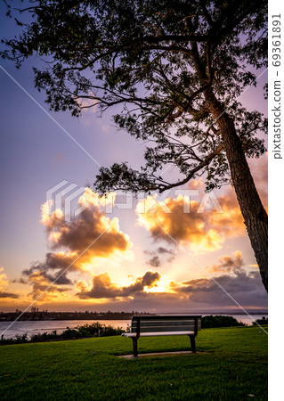 Beautiful sunrise bench and wooden silhouette Beautiful sunrise bench and wooden silhouette 69361891