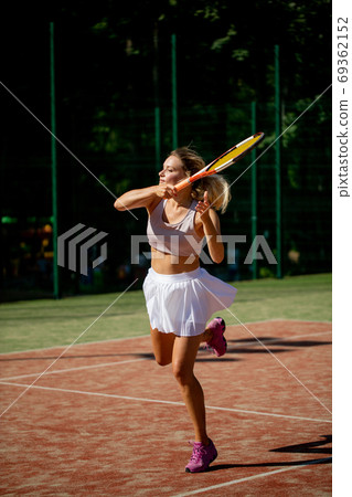Advanced female player returns a ball during second set of International Cup 69362152
