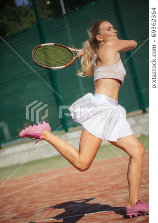 Young woman playing tennis, close up 69362364