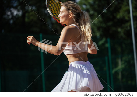 Young woman playing tennis, close up 69362365