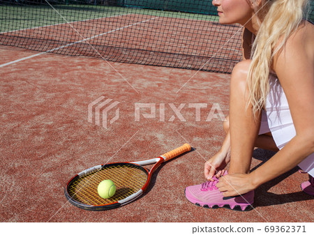 Legs of female tennis player.Close up image. 69362371