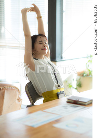 Stretching business woman Stretching business woman 69362538