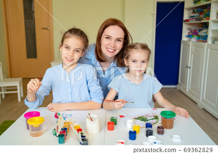 mother with little girls drawing brush and paints mother with little girls drawing brush and paints 69362829