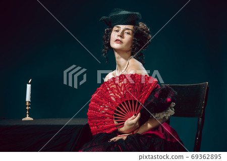 Young woman as Anna Karenina on dark blue background. Retro style, comparison of eras concept. 69362895