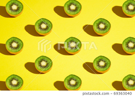 Kiwi fruits pattern on yellow background Kiwi fruits pattern on yellow background 69363040