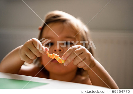 Caucasian toddler girl playing modeling play dough at home with mother. Homeschooling concept Caucasian toddler girl playing modeling play dough at home with mother. Homeschooling concept 69364770