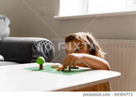 Caucasian toddler girl playing modeling play dough at home with mother. Homeschooling concept Caucasian toddler girl playing modeling play dough at home with mother. Homeschooling concept 69364773