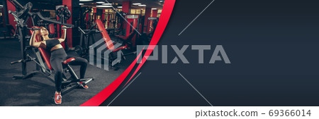 Female athlete training hard in the gym. Fitness and healthy lifestyle concept. Flyer with copyspace. 69366014