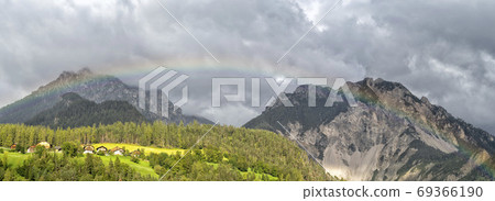 rainbow over the mountains in san vigilio in dolomites 69366190