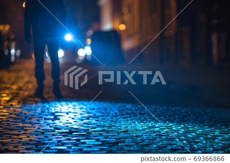 The man with a flashlight inspect the road. Evening night time 69366866