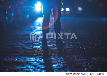 The man stand on the stone road. Evening night time. Telephoto lens shot 69366891