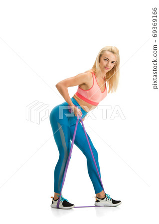 Beautiful female fitness coach practicing isolated on white studio background 69369166