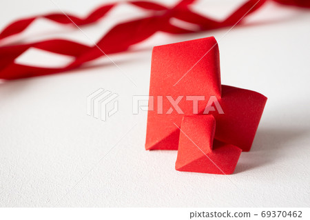 Two red origami hearts and satin ribbons on white background in Two red origami hearts and satin ribbons on white background in 69370462
