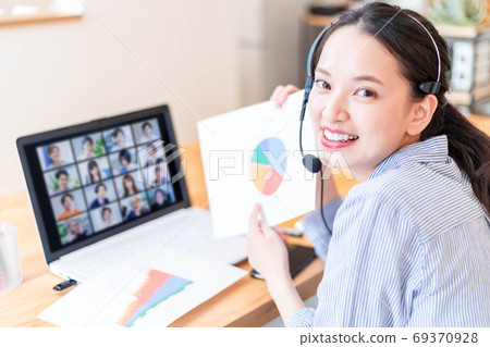Young female employee attending an online meeting Young female employee attending an online meeting 69370928