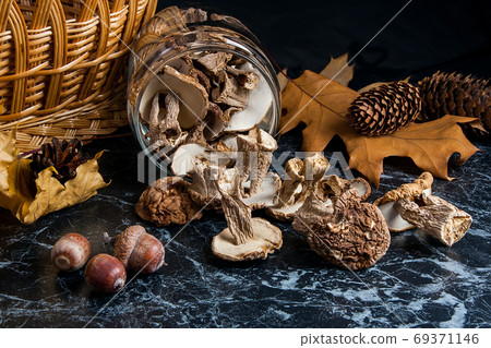 Dry wild mushrooms on black marble background. Dry wild mushrooms on black marble background. 69371146