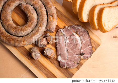 Sliced roasted traditional homemade sausage with spices and herb Sliced roasted traditional homemade sausage with spices and herb 69371148