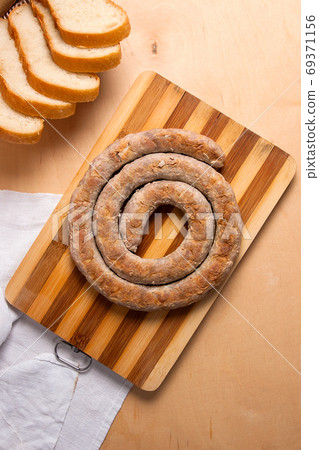 Baked traditional homemade sausage with spices and herbs.. 69371156