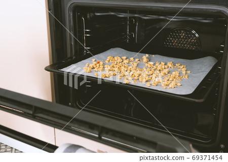 Made homemade granola in bake, healthy breakfast concept. Toned 69371454