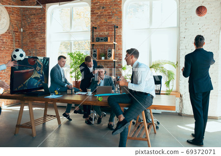 Happy colleagues having fun in office while their colleagues working hard Happy colleagues having fun in office while their colleagues working hard 69372071